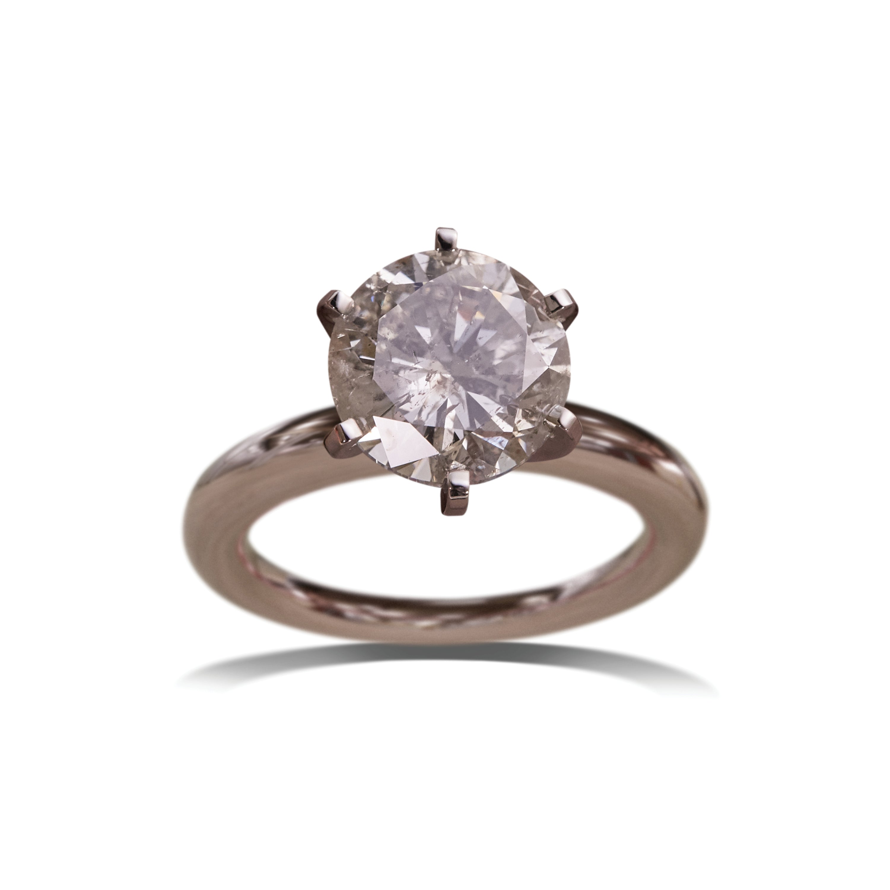 Rose gold ring with a diamond on a white background