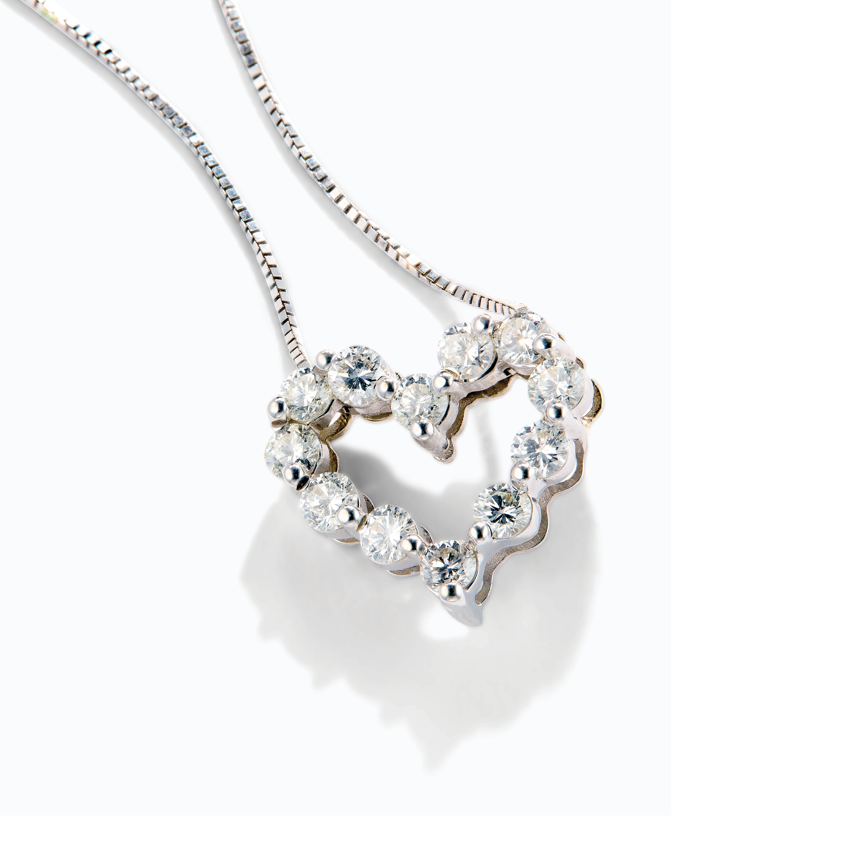 Heart-shaped diamond necklace on a white background