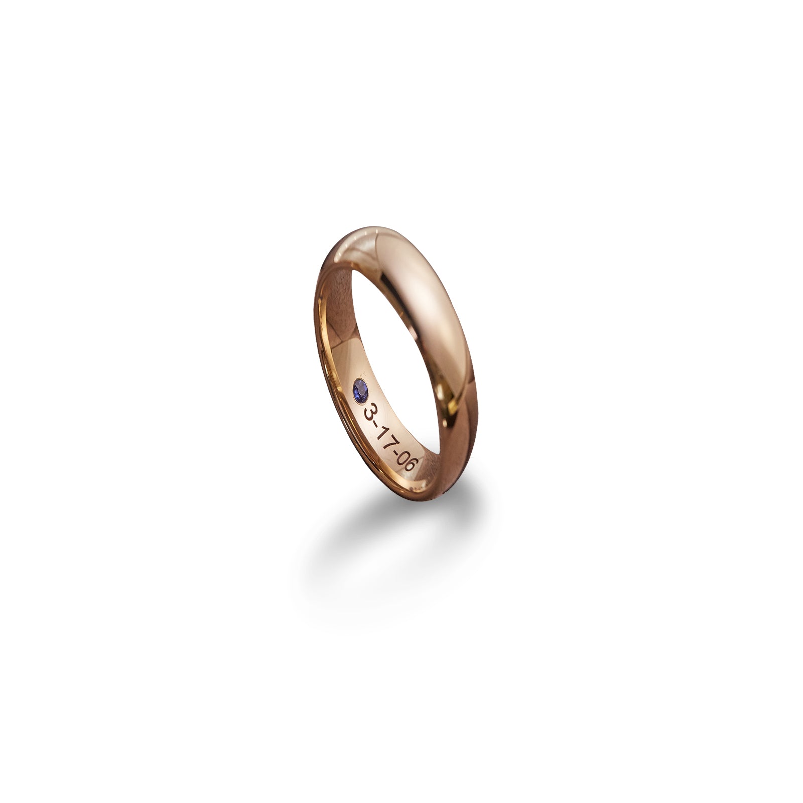 Rose gold ring with a small gemstone on a white background