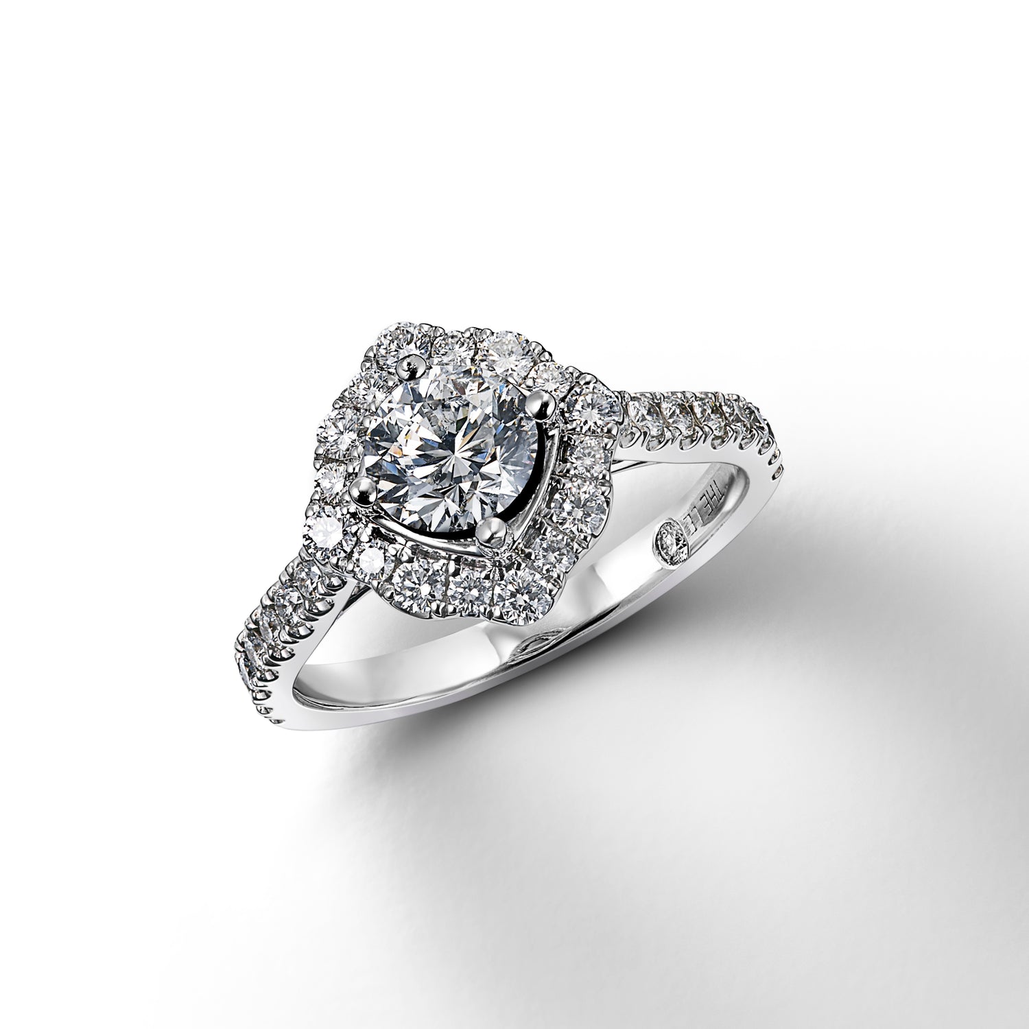 White gold diamond ring shown with center stone loose in mounting