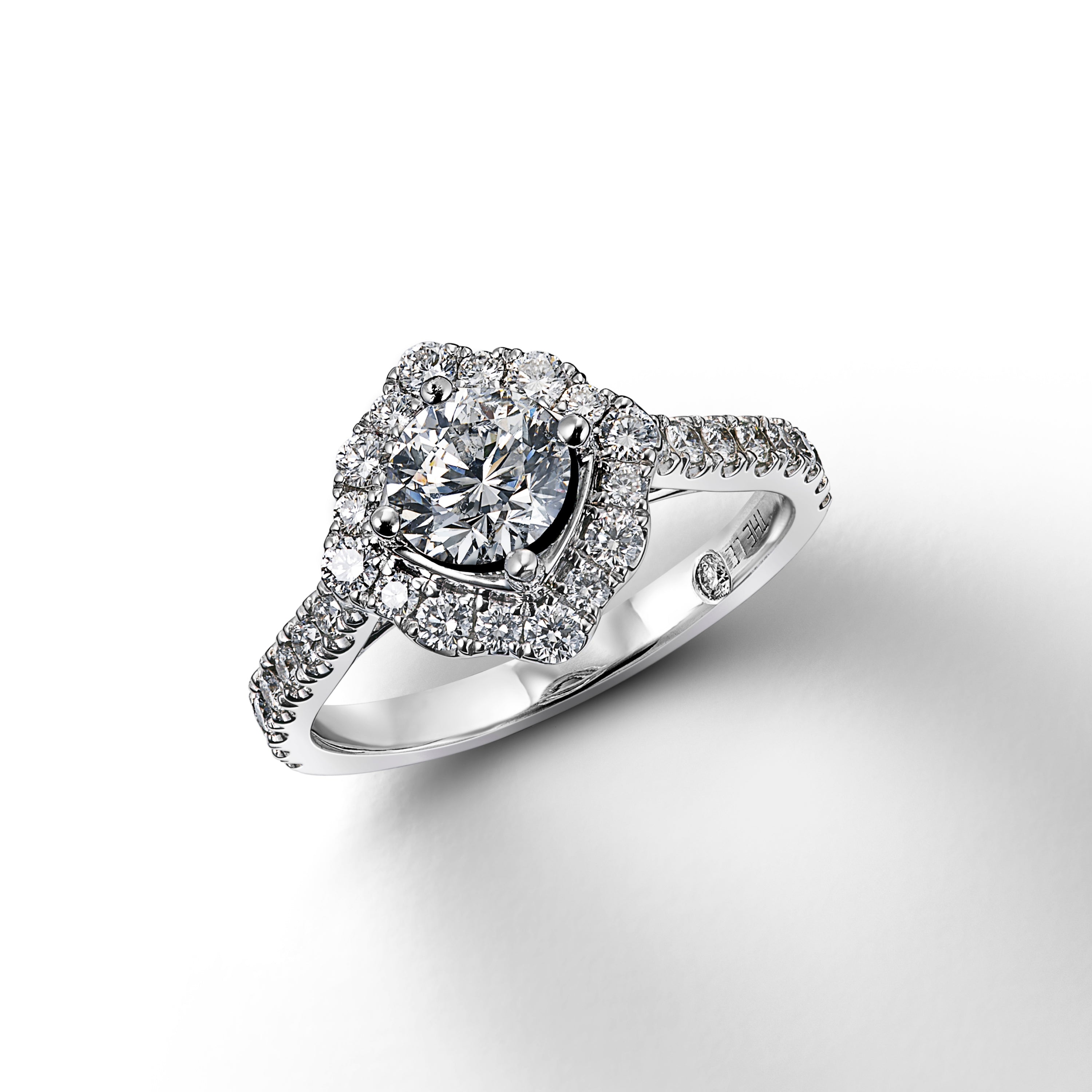White gold diamond ring shown with center stone loose in mounting