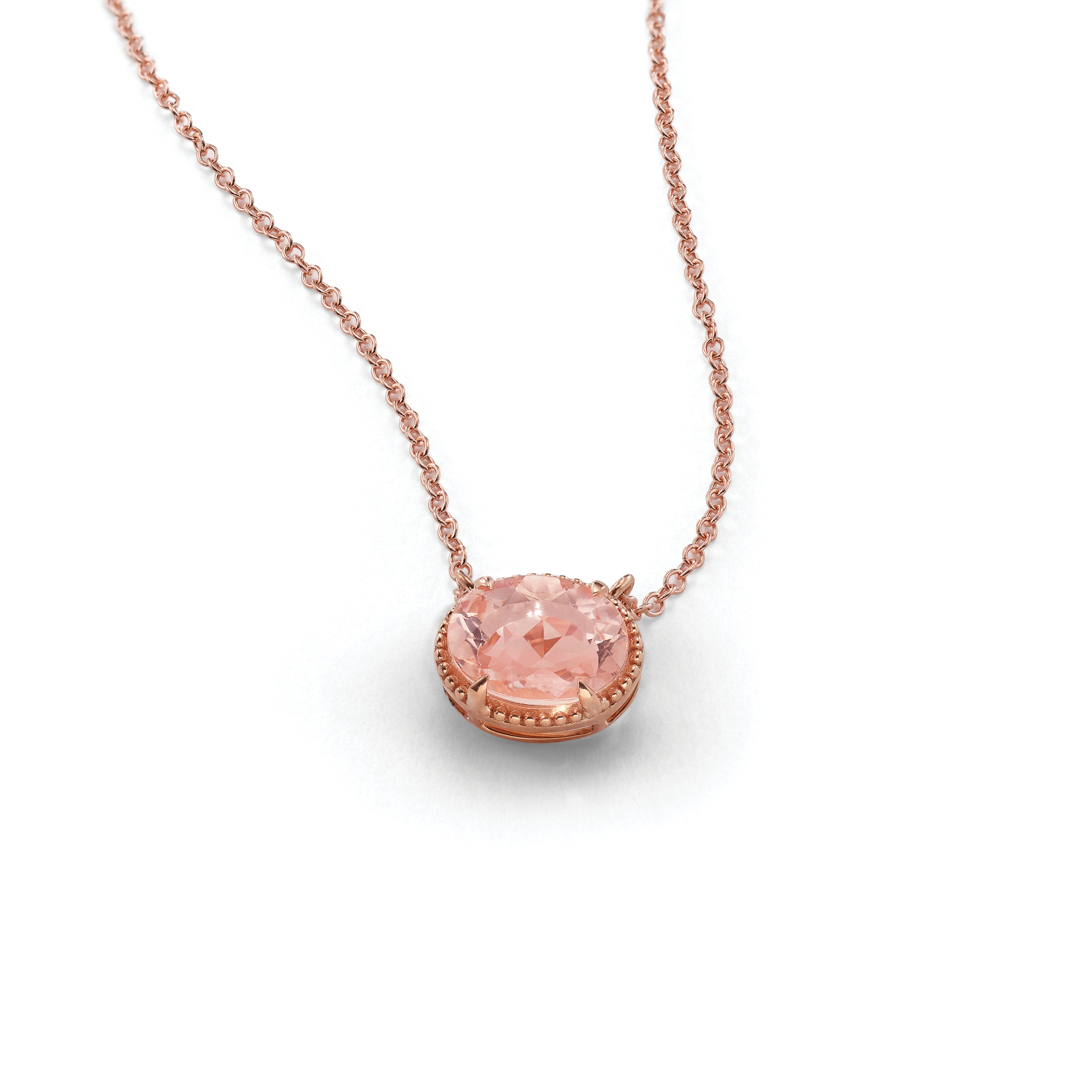 Necklace with a pink gemstone pendant on a white background